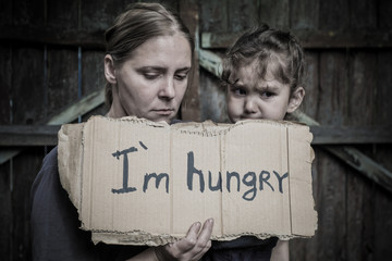 A woman with a child holding a sheet of paper. On the paper label sheet, 