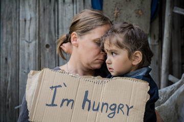 A woman with a child holding a sheet of paper. On the paper label sheet, 