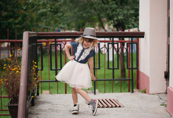 little funny girl posing outdoors