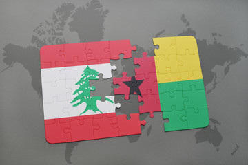 puzzle with the national flag of lebanon and guinea bissau on a world map background.
