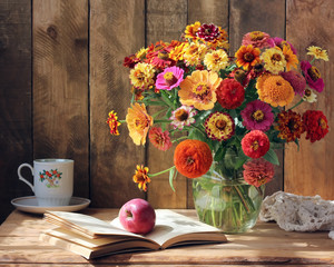 Bouquet of garden flowers, an Apple and a book.