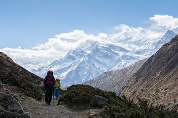 Fototapeta na wymiar hikers walking on the trail in Nepal, on Annapurna Circuit