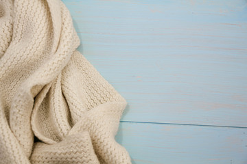 Cosy soft winter background, knitted sweater Cup hot coffee old vintage wooden board. Christmas holidays at home. place for text, Top view, flat lay with copy space for slogan or text message