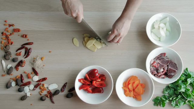 Female Hands Cutting Garlic, Making Salad. Top View Chief Cutting Vegetables. Healthy Lifestyle, Diet food