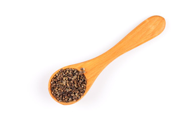 Decorticated cardamom seeds in a wooden spoon