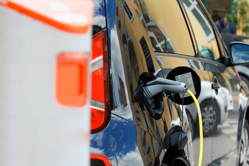 Close up of the power supply plugged into an electric car being