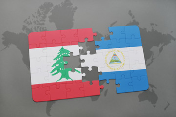 puzzle with the national flag of lebanon and nicaragua on a world map background.