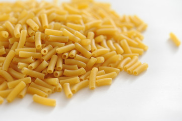 Pile of dried macaroni on white