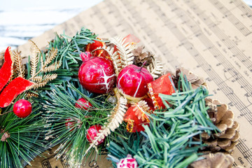 wreath fir cones, sheet music Christmas songs concept of preparing for the holidays, turquoise shabby wooden table background. place for text, Top view flat lay with copy space for slogan text message