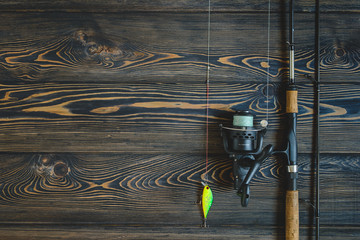 fishing tackle on a wooden table. toned image. place for the text