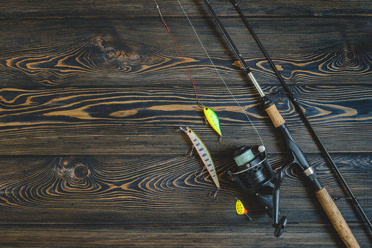fishing tackle on a wooden table. toned image. place for the text