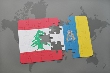 puzzle with the national flag of lebanon and canary islands on a world map background.