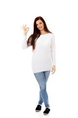Young beautiful woman showing OK sign