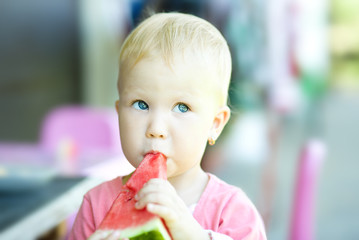 Girl is eating watermelon