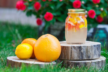 Fresh lemonade from lemon and grapefruit and orange in a jar on