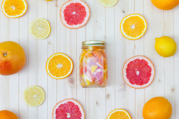 Fresh lemonade in a jar with slices of grapefruit, orange, lemon