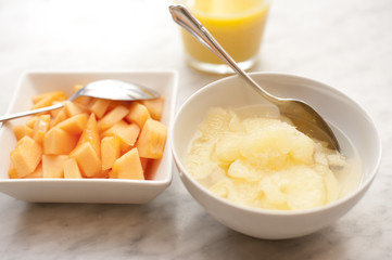 Close-up of delicious sliced pineapple and mango in bowls