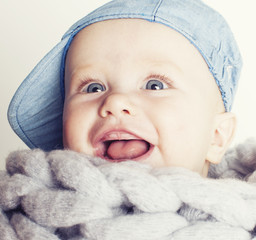 little cute red head baby in scarf all over him close up isolated, adorable kid, lifestyle people concept