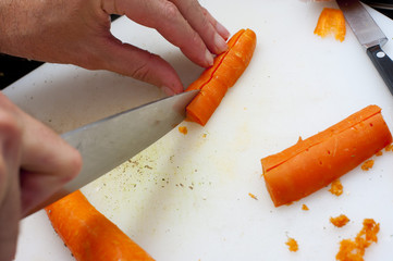 Man chopping fresh carrots