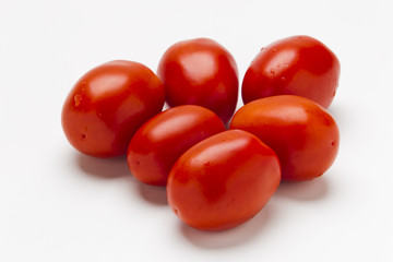 Red plum tomatoes on a white background