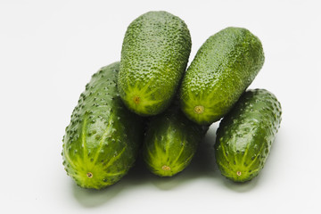 Green cucumbers on a white background
