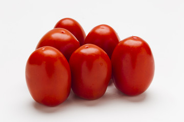 Red plum tomatoes on a white background