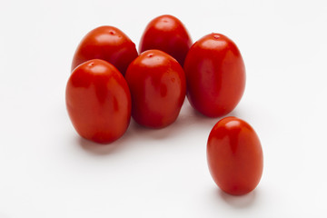 Red plum tomatoes on a white background