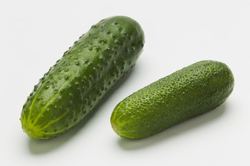 Green cucumbers on a white background