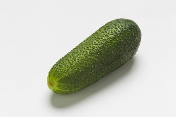 Green cucumbers on a white background