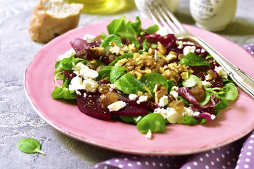 Beetroot salad with raisins,walnuts,feta and greeen leaves mix.
