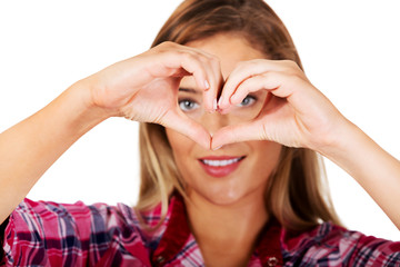 Young woman making a heart hand gesture