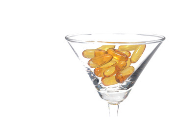 Cod liver oil capsules in martini glass