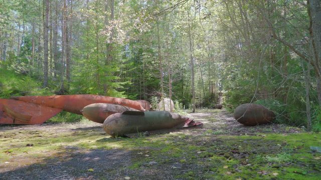 Old rusty torpedo military tools found on the ground in the forest