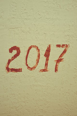 2017 sign symbol on light wall texture copy space