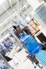 Water factory - Water bottling line for processing and bottling pure spring water into gallons. Selective focus.