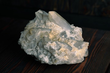 Rock crystal mineral stone on the wooden background. Quartz variety.