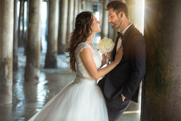 Naklejka premium Newlywed couple looking into each others eyes true love just married classic dress