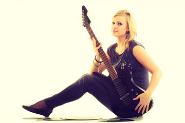 Woman with electrical guitar and vinyl record.