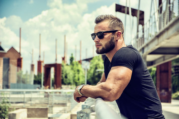 Handsome Muscular Hunk Man Outdoor in City Setting. Showing Healthy Body While Looking Away