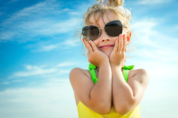 A Girl in Sunglasses On a Background Of Blue Sky