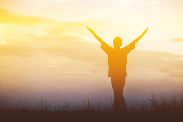 Men, who welcome sunrise with raised hands and enjoying landscap