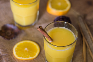Rustic orange juice drink with cinnamon stick