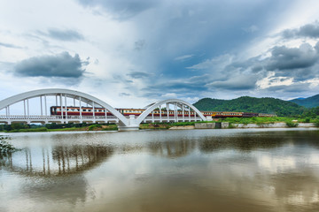 Trains of Thailand is moving into the white bridge "Tha Chomphu". The bridge over the railway tracks are located at lamphun Thailand's country.