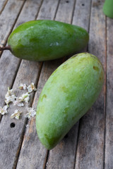 Fresh green mango on wooden table