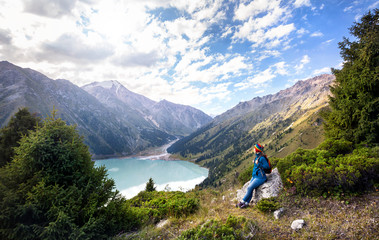 Tourist woman with backpack at the mountains