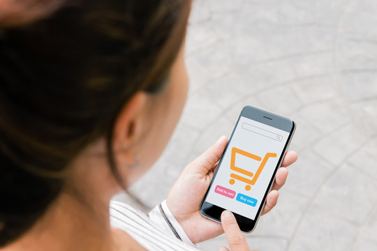 close up woman use phone shopping online on thrid person view