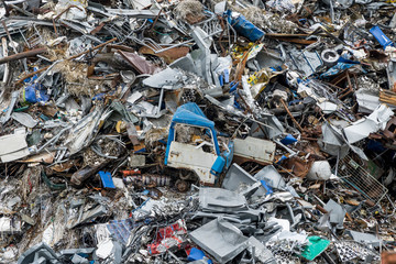 Dumping ground. Scrap metal heap. Compressed crushed cars is returned for recycling. Iron waste ground in the industrial area. Stacked automobile