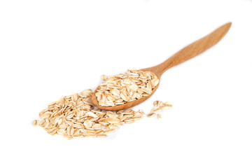 Oats flakes pile in wood spoon on white background