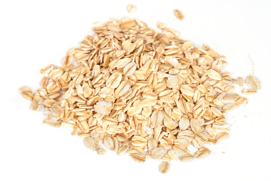 Oats flakes pile on white background