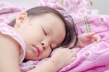 Little asian girl sleeping on bed and bite by mosquitoes ,focus
